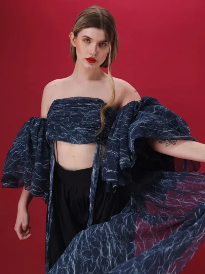 Live model fashion still, floral print dress on red backdrop