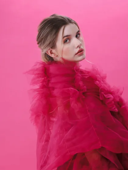 Live model fashion still, pink tulle dress with flower detail